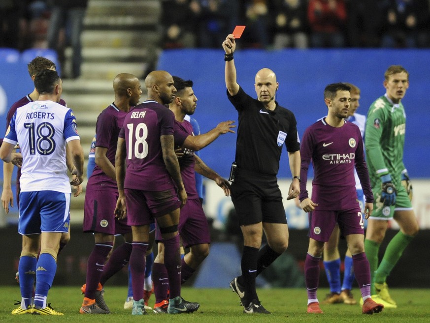 Referee Anthony Taylor shows a red card to Manchester City&#039;s Fabian Delph, 18, during the English FA Cup fifth round soccer match between Wigan Athletic and Manchester City at The DW Stadium, Wig ...