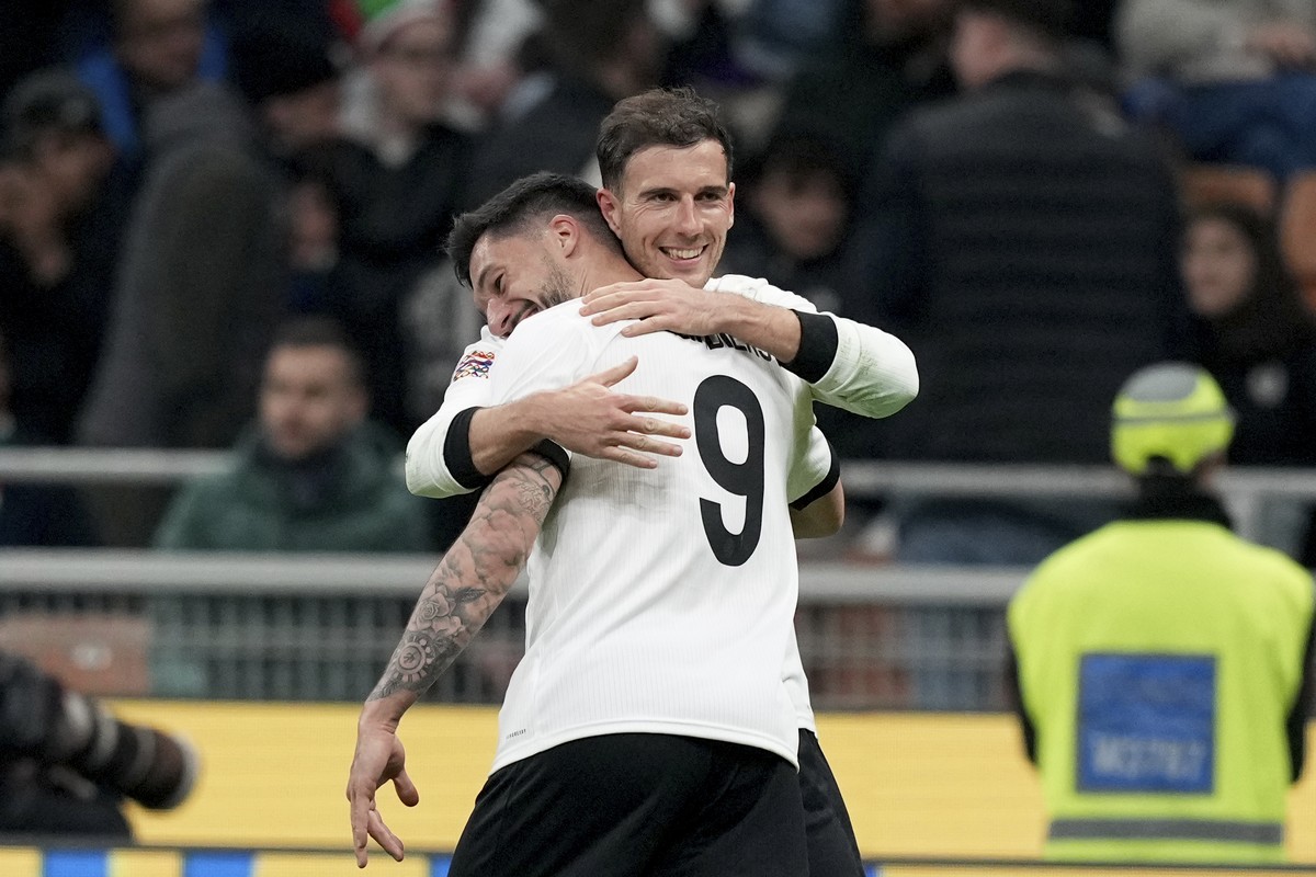Germany's Leon Goretzka, right, celebrates with Tim Kleindienst after scoring his side's second goal during the Nations League quarterfinals first leg soccer match between Italy and Germany, ...