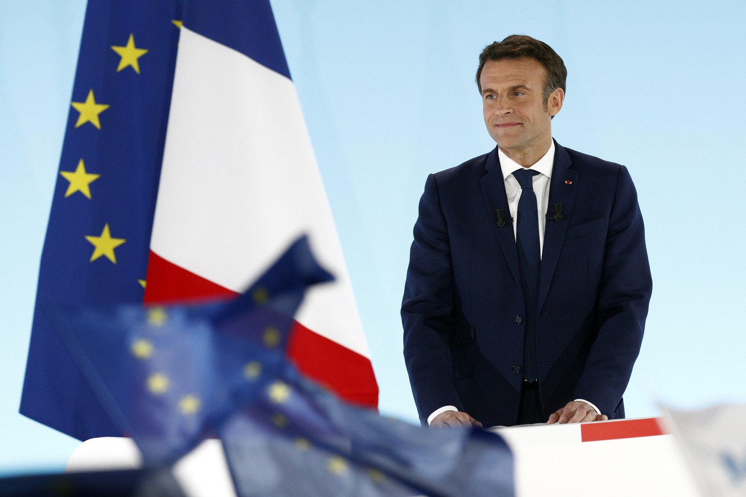 epa09883438 French President and candidate for re-election Emmanuel Macron reacts after results in the first round of the French presidential elections in Paris, France, 10 April 2022. According to in ...