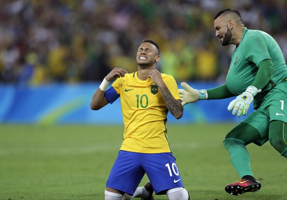 Brazil&#039;s Neymar cries as he kneels down to celebrate with teammate goalkeeper Weverton after scoring the decisive penalty kick during the final match of the men&#039;s Olympic football tournament ...