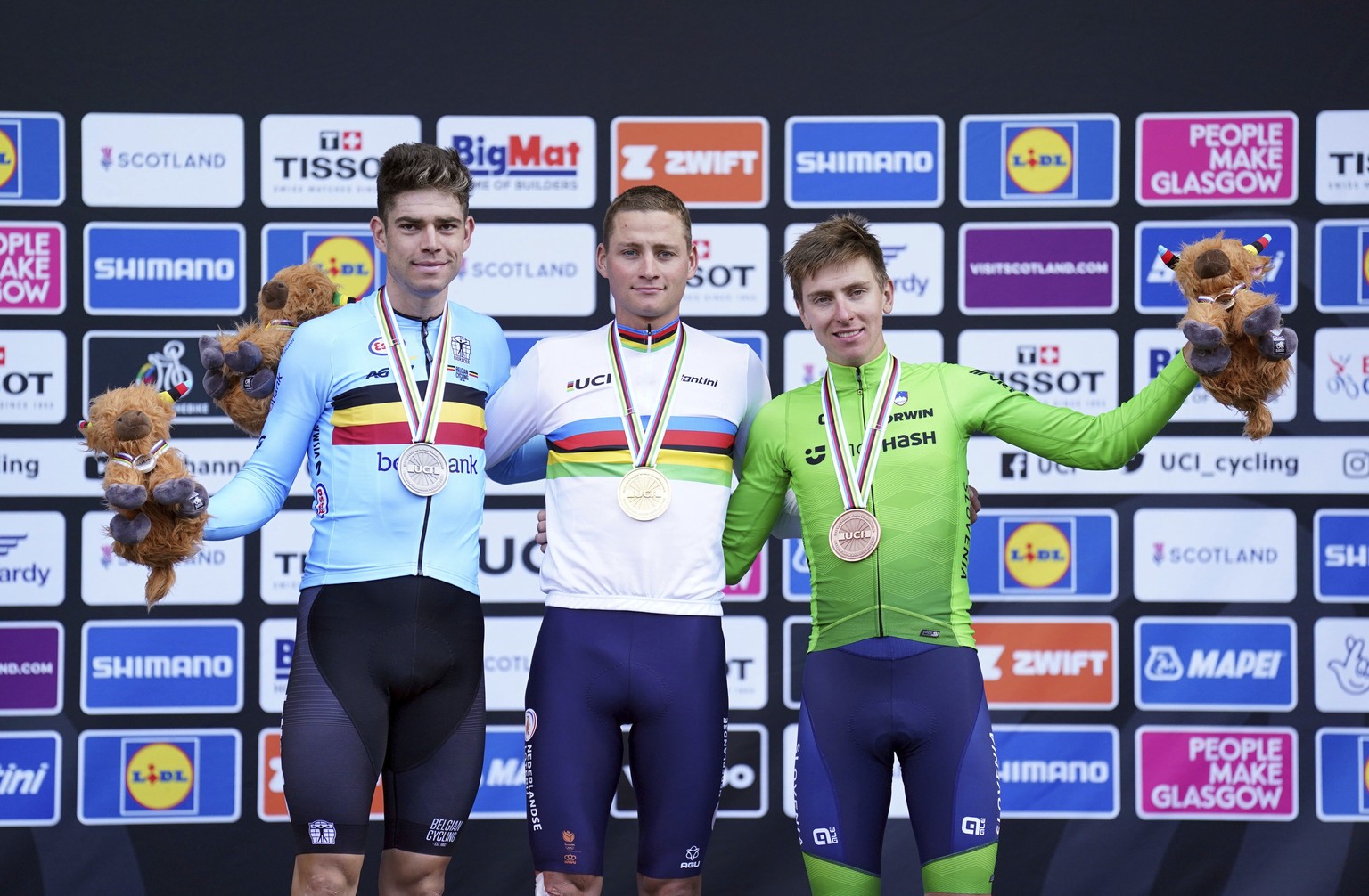 From left, silver medalist Wout van Aert, of Belgium, gold medalist Mathieu van der Poel, of The Netherlands, and bronze medalist Tadej Pogacar, of Slovenia, on the podium after on day four of the 202 ...