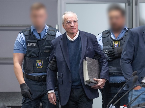 epa11388520 Main defendant Heinrich XIII Prinz Reuss (C) is led into the courtroom to attend another day of the Reich Citizens Group trial at the Higher Regional Court in Frankfurt am Main, Germany, 0 ...