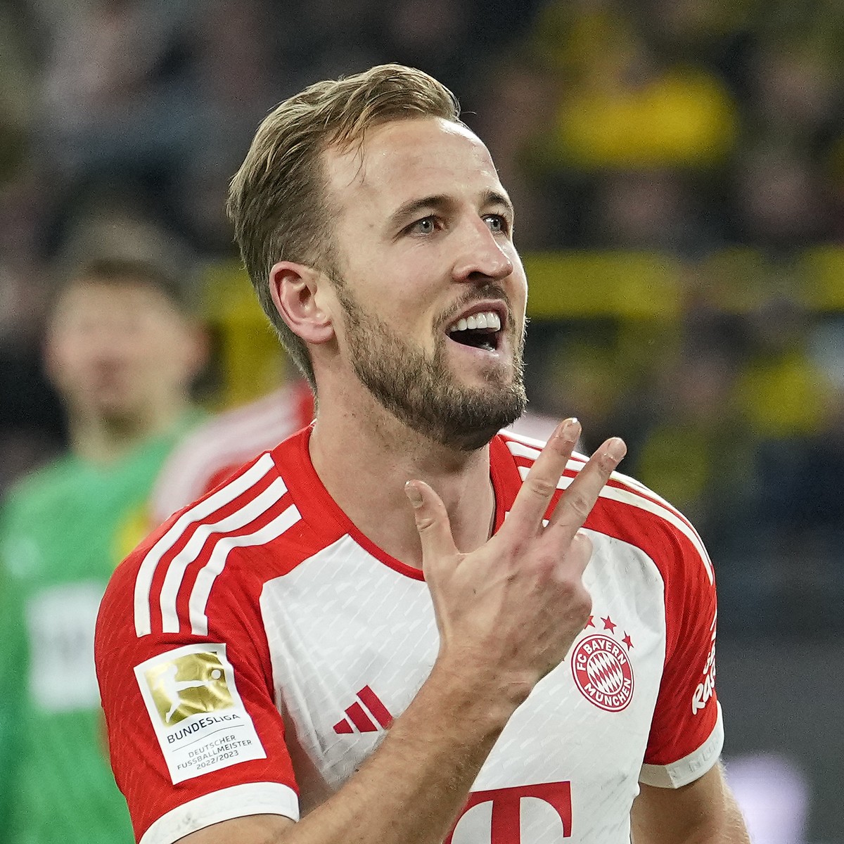 Bayern's Harry Kane celebrates showing fingers after he scored his third goal during the German Bundesliga soccer match between Borussia Dortmund and Bayern Munich in Dortmund, Germany, Saturday, ...