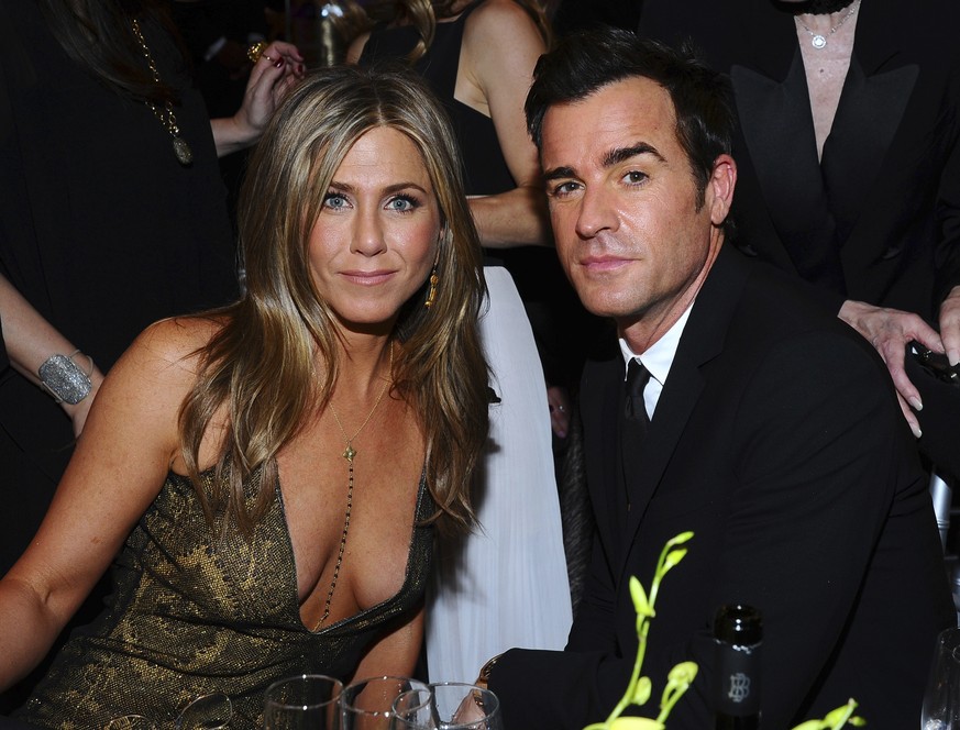 FILE - In this Jan. 25, 2015 file photo, Jennifer Aniston, left, and Justin Theroux pose in the audience at the 21st annual Screen Actors Guild Awards in Los Angeles. The couple announced Thursday, Fe ...