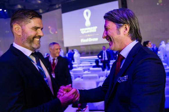 Switzerland&#039;s soccer national team head coach Murat Yakin, right, talks with former Swiss goalkeeper Pascal Zuberbuehler, left, during the draw for the 2022 FIFA World Cup at the Doha Exhibition  ...