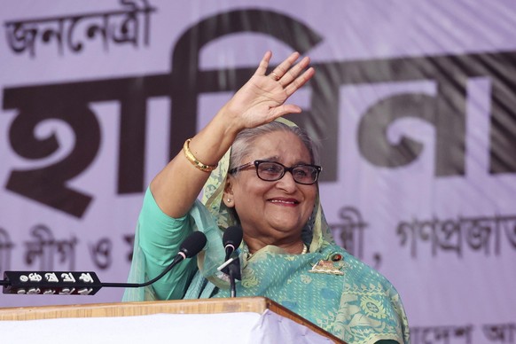 Bangladesh's Prime Minister Sheikh Hasina waves to the gathering during an election campaign rally for her ruling Awami League party, ahead of the upcoming national elections, in Sylhet, Banglade ...