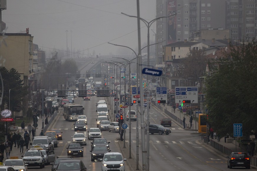 Traffic moves along Bill Clinton Boulevard during smog and heavy air pollution in Kosovo capital Pristina, on Friday, Dec. 20, 2019. (AP Photo/Visar Kryeziu)