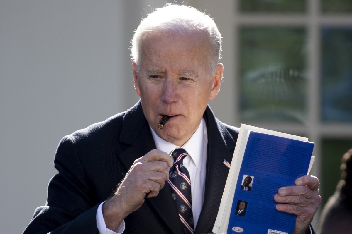 epaselect epa09859454 US President Joe Biden autographs a book for a guest following a ceremony in which he signed into law the Emmett Till Antilynching Act, in the Rose Garden of the White House, in  ...