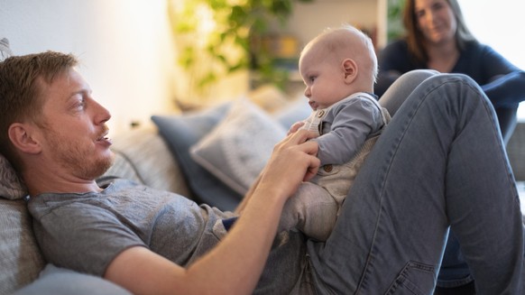 Ein Vater umsorgt an seinem freien Tag gemeinsam mit seiner Frau zu Hause seinen vier Montate alten Sohn, fotografiert am 15. Mai 2020 in Aarau. (KEYSTONE/Gaetan Bally)