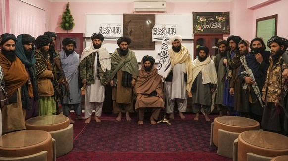 Badghis Deputy Governor Molwi Mohibullah Asad (in the middle) and other members of Taliban line up for the interview in the governors office in Qala-e-Naw Afghanistan, Saturday, Dec. 13, 2021. Severe  ...