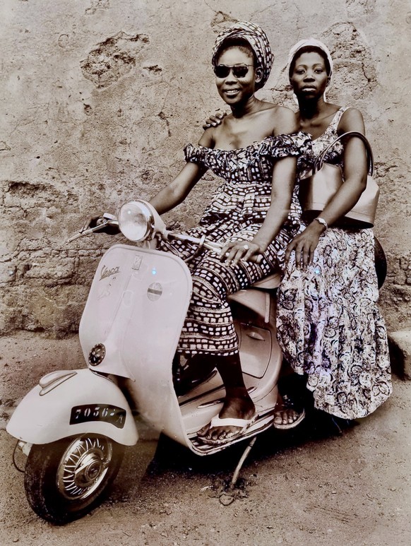 Senegales ladies on a Vespa, 1957. 

https://www.seydoukeitaphotographer.com/