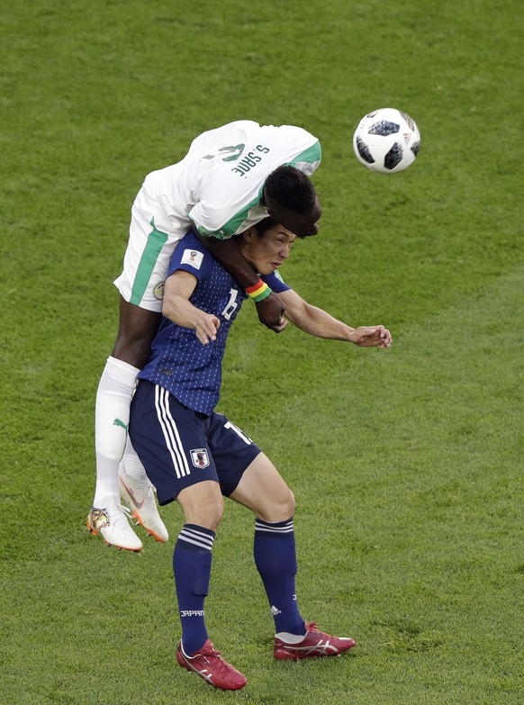 Senegal&#039;s Salif Sane, left, and Japan&#039;s Yuya Osako, jump for the ball during the group H match between Japan and Senegal at the 2018 soccer World Cup at the Yekaterinburg Arena in Yekaterinb ...