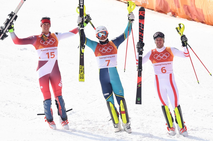 epa06552424 (L-R) Silver medal winner Ramon Zenhaeusern of Switzerland, gold medal winner Andre Myhrer of Sweden and bronze medal winner Michael Matt of Austria react after the Men&#039;s Slalom at th ...