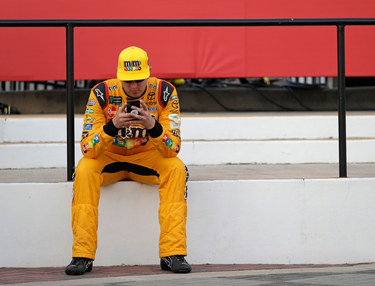 FILE - Kyle Busch waits in Victory Lane after winning the pole position for the NASCAR Cup series auto race at Charlotte Motor Speedway in Charlotte, N.C., Thursday, May 24, 2018. (AP Photo/Chuck Burt ...