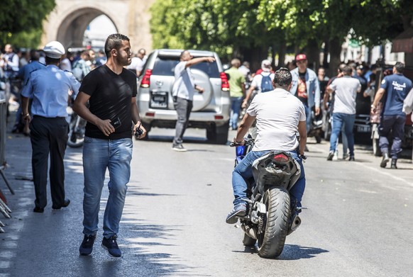 epa07677025 Police take measures at the scene after a suicide bombing targeted a police vehicle in the Tunisian capital in Tunis on 27 June 2019. according to media reports, two suicide bomb attacks n ...