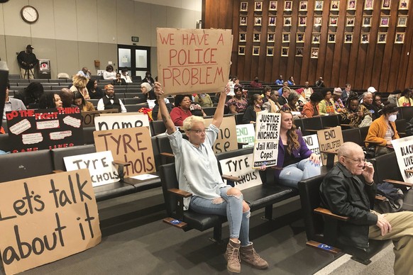 Activists hold signs addressing the Tyre Nichols case at a Memphis City Council meeting, Tuesday, Feb. 7, 2023, in Memphis, Tenn. (AP Photo/Adrian Sainz)