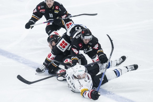 From left, Lugano&#039;s player Marco Mueller, Lugano&#039;s player Marco Zanetti, Fribourg&#039;s player Sandro Schmid, during the game 4, 1/4 final playoff of National League 2023/24 between HC Luga ...