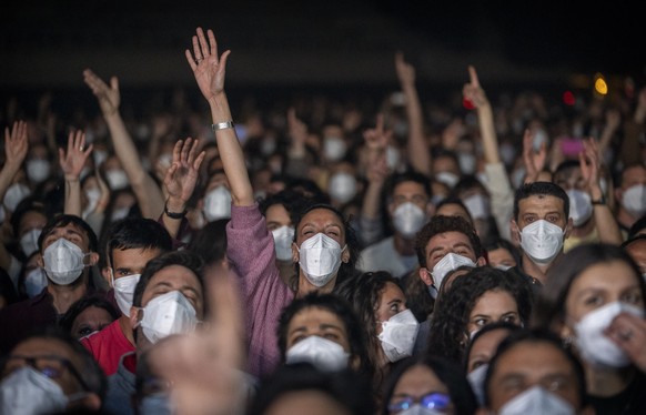 People react during a music concert in Barcelona, Spain, Saturday, March 27, 2021. Five thousand music lovers are set to attend a rock concert in Barcelona on Saturday after passing a same-day COVID-1 ...