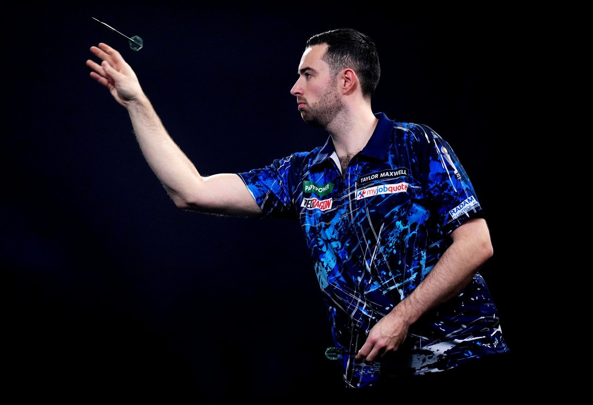 England's Luke Humphries in action during his match against Singapore's Paul Lim on day twelve of the World Darts Championship at the Alexandra Palace, in London, Monday, Dec. 22, 2025. (Joh ...