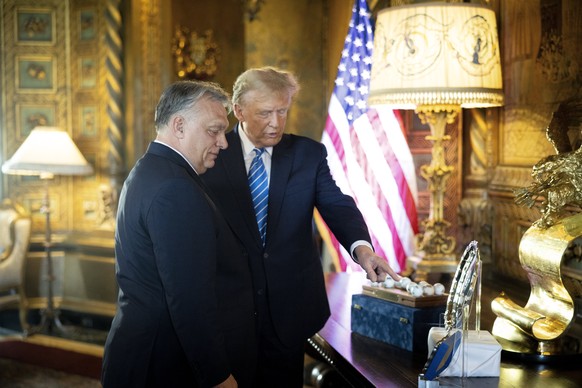 epa11208140 A handout photo made available by the Hungarian Prime Minister&#039;s Office shows ..former US President and Republican presidential candidate Donald Trump (R) talking to Hungarian Prime M ...