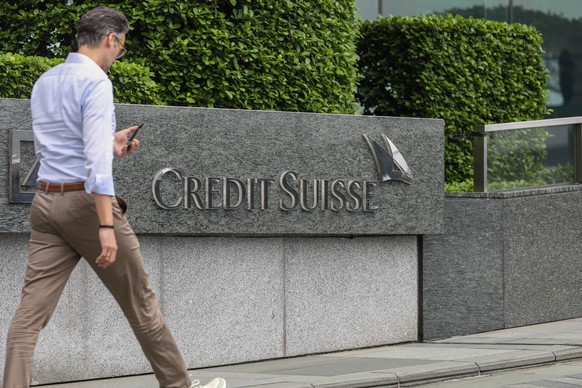 epa10536140 A man walks past the logo of Credit Suisse in Hong Kong, China, 22 March 2023. The Hong Kong Monetary Authority said Credit SuisseÄôs assets in Hong Kong made up 0.5 percent of the bankin ...