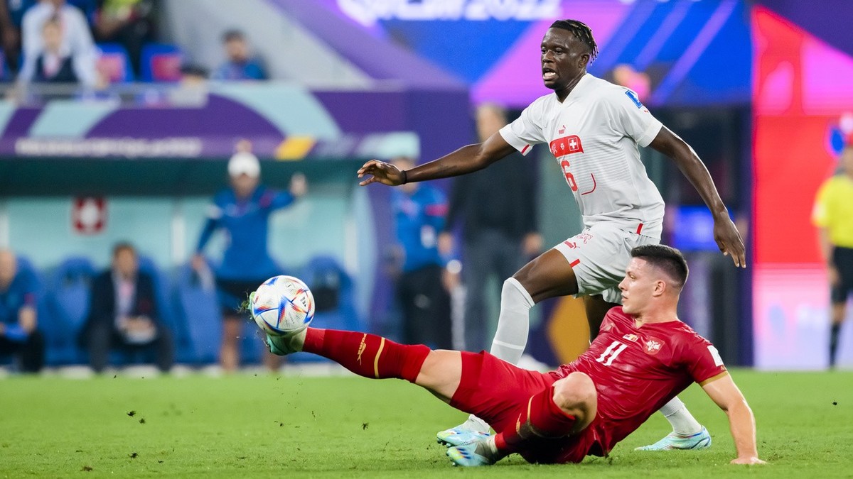 Switzerland's midfielder Denis Zakaria, left, fights for the ball with Serbia's forward Luka Jovic, right, during the FIFA World Cup Qatar 2022 group G soccer match between Serbia and Switze ...