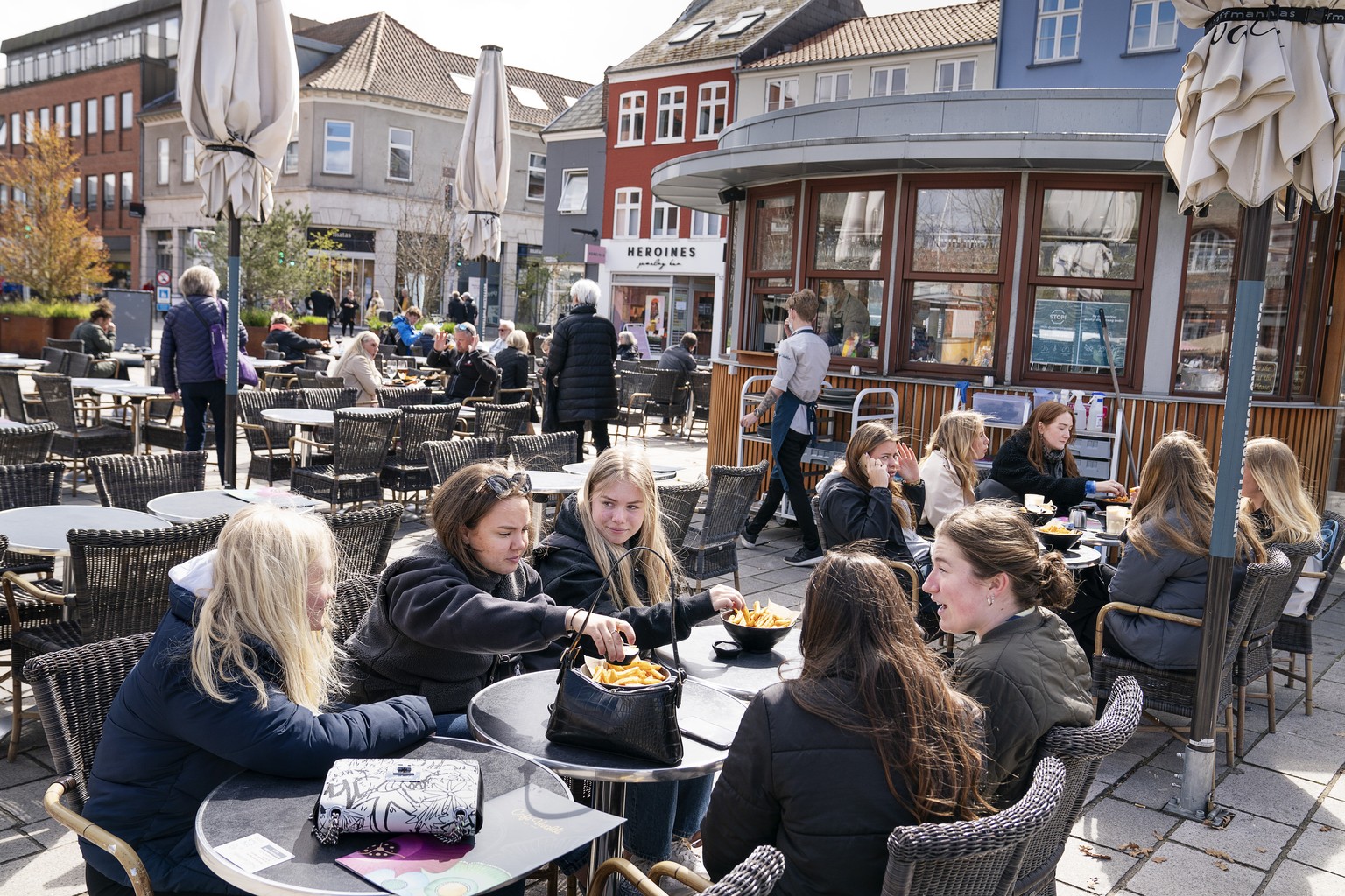FILE - In this Wednesday April 21, 2021 file photo, people sit outside a restaurant for outdoor service in Roskilde Denmark, as cafes and bars reopened. After 548 days with restrictions to limit the s ...