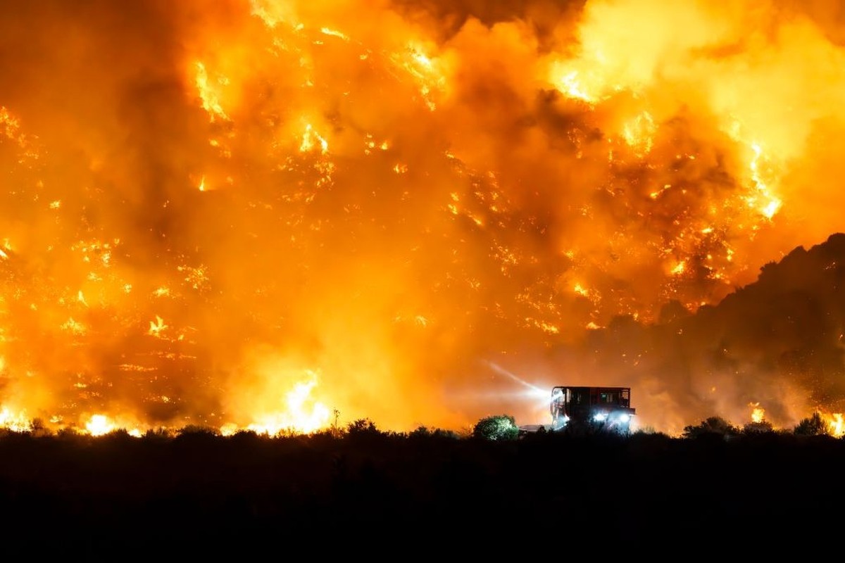 GORMAN, CALIFORNIA, UNITED STATES - 2024/06/15: A Cal Fire Bulldozer cuts a line as the mountain is engulfed in flames. The Post Fire consumes Gorman, California. The fire has consumed a total of 10,5 ...