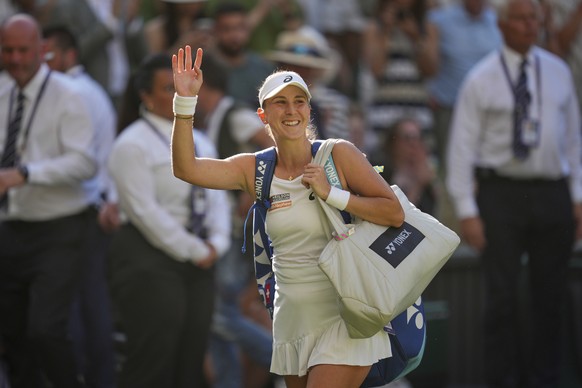Switzerland&#039;s Belinda Bencic waves as she leaves the court after losing to Poland&#039;s Iga Swiatek during a women&#039;s singles semifinal match at the Wimbledon Tennis Championships in London, ...