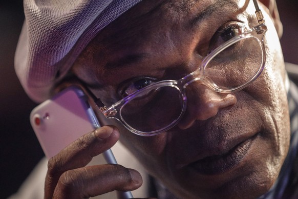 epa07369546 US actor Samuel L. Jackson holds up a phone to his ear during a Captain Marvel fan event at the Marina Bay Sands Convention Centre in Singapore, 14 February 2019. Captain Marvel will open  ...