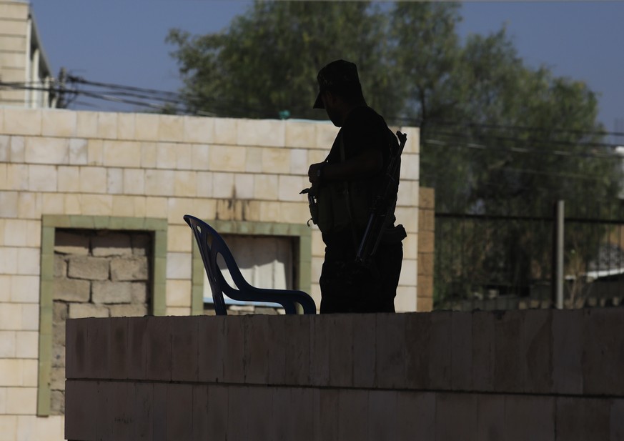 epa13279447 A Houthi soldier is silhouetted while standing guard near a sports hall building targeted by a previous Saudi-led airstrike, in Sana'a, Yemen, 03 October 2026. Yemen's Houthis cl ...