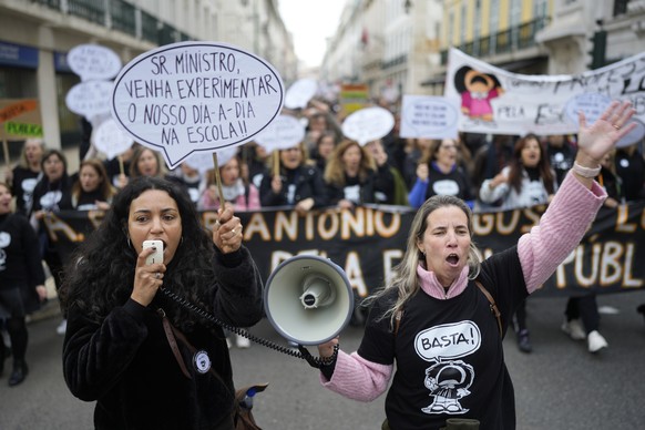 Protestors march through downtown Lisbon during a demonstration by teachers in Lisbon, Saturday, Feb. 11, 2023. Among the many teachers&#039; demands are better working conditions, salaries, careers p ...