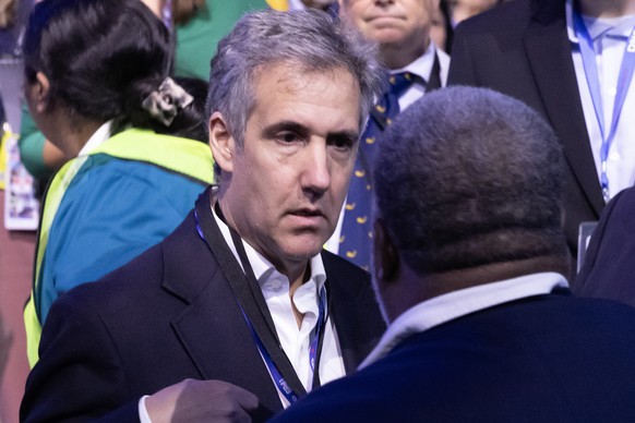 epa11557239 Michael Cohen, former attorney for former US President Donald J. Trump presents his credential during the second night of the Democratic National Convention (DNC) at the United Center in C ...