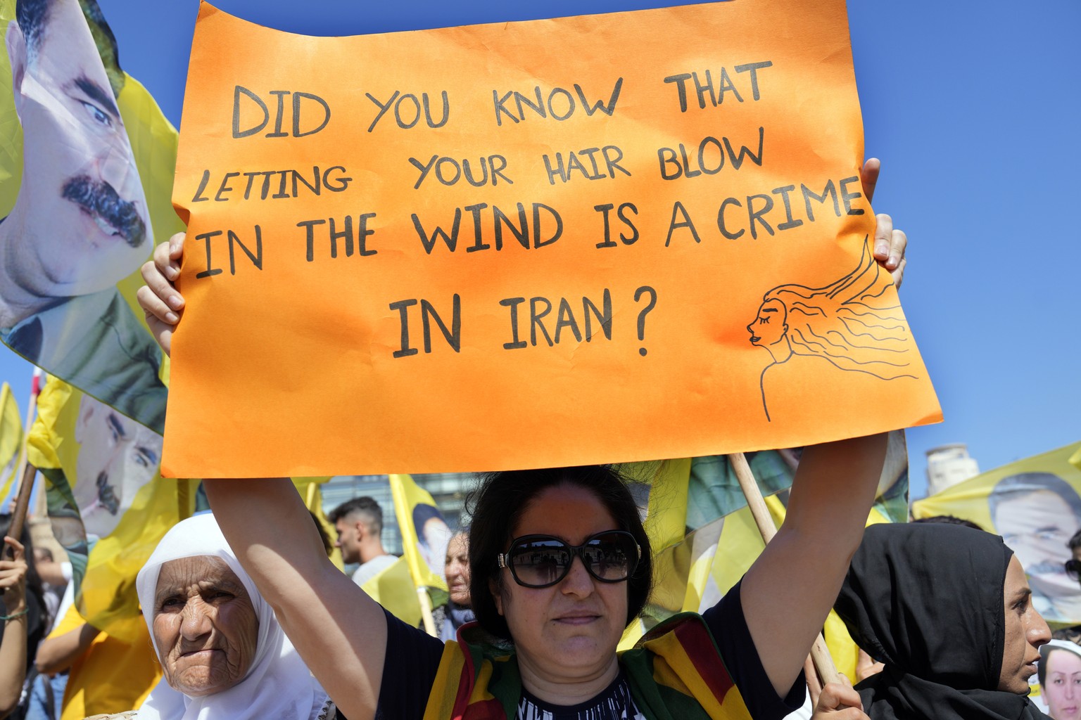 Kurdish supporters of the Kurdistan Workers&#039; Party, known as PKK, hold placards and wave party flags with portraits of their jailed leader Abdullah Ocalan, during a protest against the death of M ...