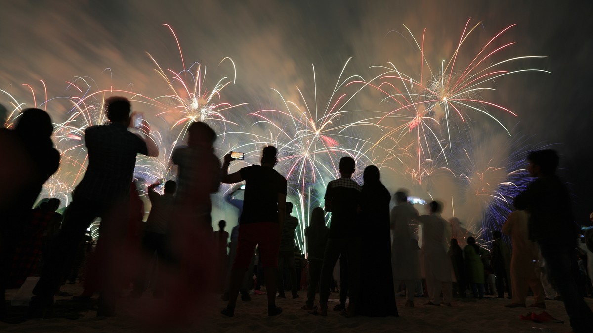 epa07204517 People watch fireworks illuminate the sky over the Corniche of Abu Dhabi as a performance to celebrate the UAE's 47th National Day and the Year of Zayed in Abu Dhabi, United Arab Emir ...