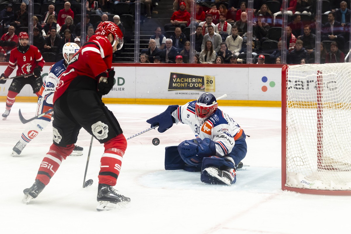 goaltender Simon Hrubec (ZSC), right, saves a shot from Ahti Oksanen (LHC), left, during the first leg of the National League Swiss Championship final playoff game between Lausanne HC, LHC, and ZSC Li ...