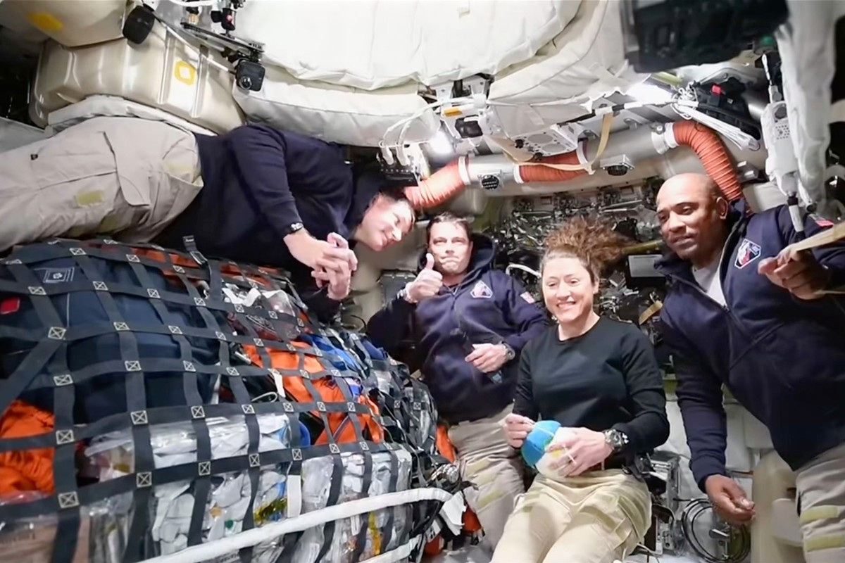 This image from video provided by NASA shows the Artemis II crew, from left, Canadian astronaut and mission specialist Jeremy Hansen, Commander Reid Wiseman, mission specialist Christina Koch and pilo ...