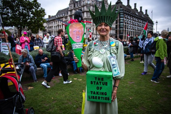 September 17, 2025, London, England, United Kingdom: A protestor seen dressed in costume as The Statue of Liberty during the Trump not welcome demonstration at Parliament Square. Around 50 protest gro ...