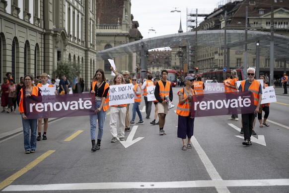 Environmental activists of Renovate Switzerland protest during a slow protest march on a road in Bern, Switzerland, on Saturday, July 1, 2023. (KEYSTONE/Anthony Anex)