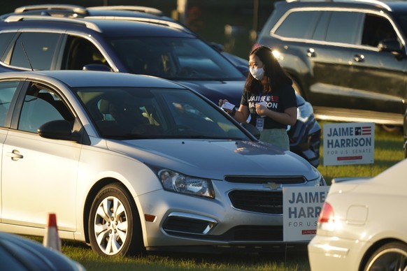 epa08776495 Campaign volunteers for Democratic South Carolina US Senate candidate Jamie Harrison, handout campaign literature during a a drive-in, get-out-the-vote concert at the Charlie W. Johnson St ...