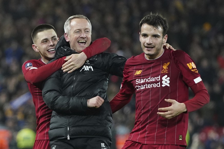 Liverpool&#039;s Under 23 coach Neil Critchley, center, celebrates with Liverpool&#039;s Pedro Chirivella, right, and Liverpool&#039;s Adam Lewis after winning the English FA Cup Fourth Round replay s ...
