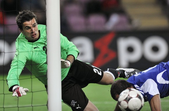 Swiss goalkeeper Eldin Jakupovic, left, saves against Cyprus&#039; defender Stelios Okkarides, during an international friendly test game between Switzerland and Cyprus at the Stade de Geneve stadium  ...