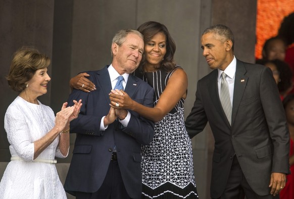 epa05603382 YEARENDER 2016 SEPTEMBER
US First Lady Michelle Obama (2-R) hugs former President George W. Bush (2-L) while President Barack Obama (R) and former First Lady Laura Bush (L) look on at the ...