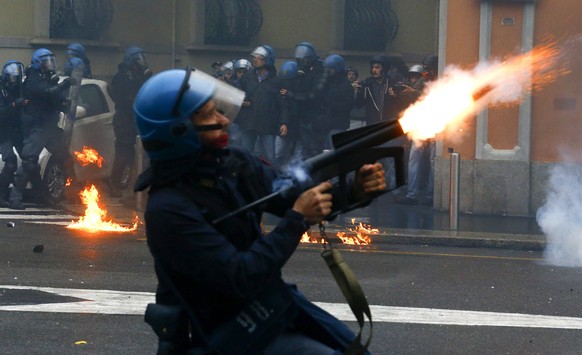 A policeman fires tear gas during a rally against Expo 2015 in Milan, Italy, May 1, 2015. Italy opens the Milan Expo on Friday, torn between hopes that the showcase of global culture and technology wi ...