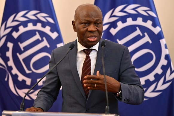 epa11425207 Director-General of the International Labour Organization (ILO) Gilbert Fossoun Houngbo speaks during a joint press conference with Hungarian Minister of Foreign Affairs and Trade Peter Sz ...
