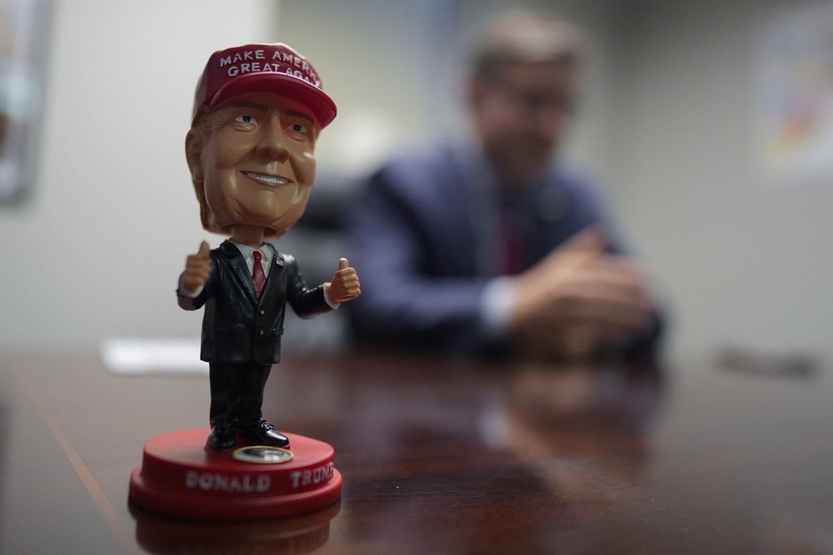 A bobblehead of Republican presidential nominee former President Donald Trump sits on the desk as Speaker of the House Mike Johnson, R-La., speaks during an interview with The Associated Press at the  ...