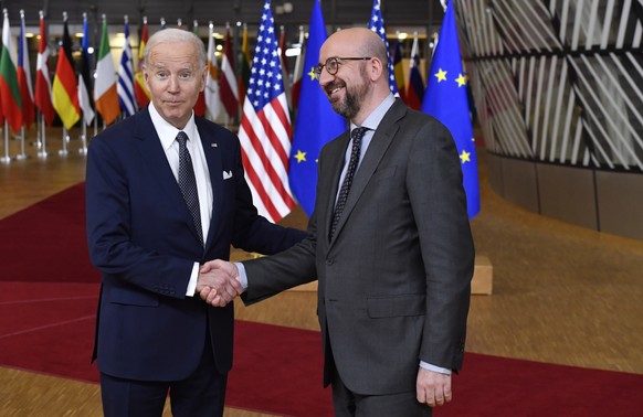 U.S. President Joe Biden, left, shakes hands with European Council President Charles Michel as he arrives for an EU summit at the European Council building in Brussels, Thursday, March 24, 2022. As th ...