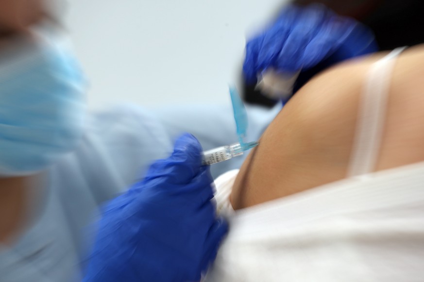 epa08739964 A nurse administers a dose of flu vaccine in Bilbao, Basque Country, northern Spain, 13 October 2020. The annual flu vaccination campaign began in the region with an aim to immunize 75 per ...