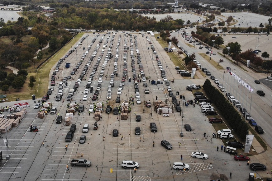 People line up in their cars to receive Thanksgiving meal boxes that include turkey and pantry items from the Tarrant Area Food Bank Friday, Nov. 20, 2020, at AT&amp;T Stadium parking lot in Arlington ...