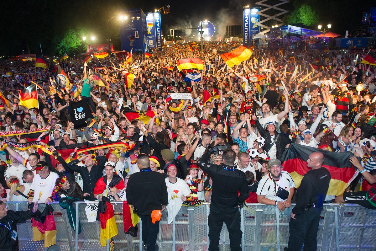 BERLIN, GERMANY - JULY 13: Fans of Germany cheer after the 2014 FIFA World Cup Final between Germany and Argentina at the Fanmeile public viewing at Brandenburg Gate on July 13, 2014 in Berlin, German ...